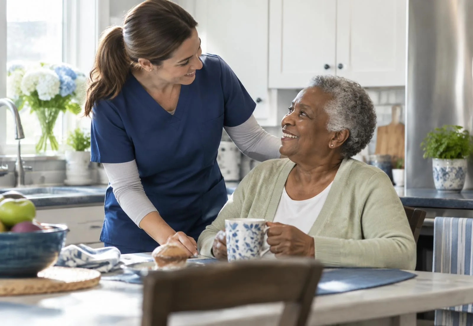 A caregiver sharing a warm moment with an older adult at home